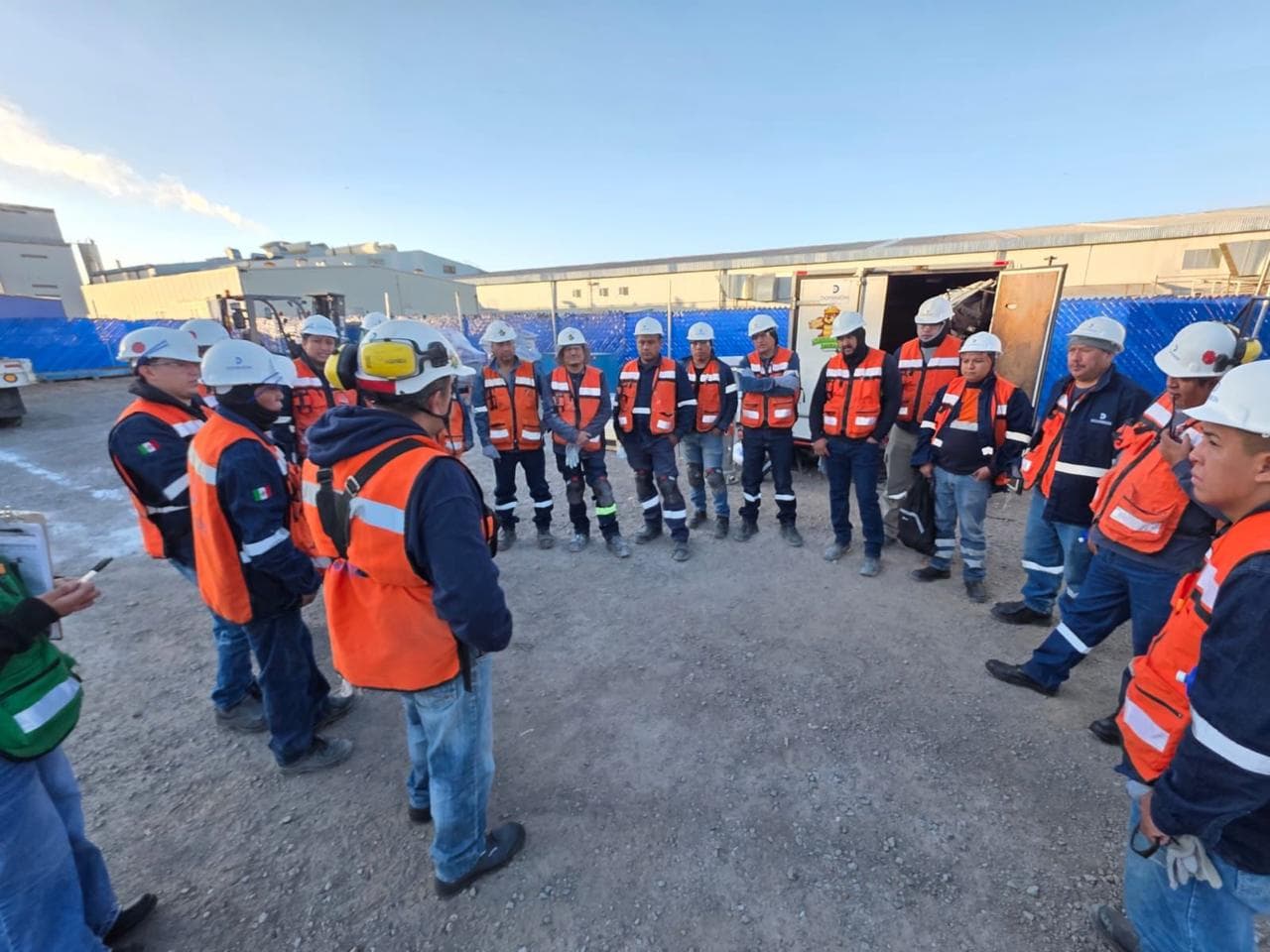 Supervisor de Grupo VAD impartiendo una charla de seguridad a personal de obra con equipo de protección personal