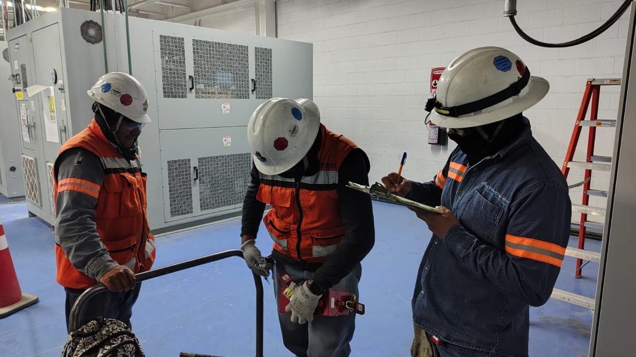 Supervisores verificando un bloqueo y candadeo de equipo con lista de verificación en planta